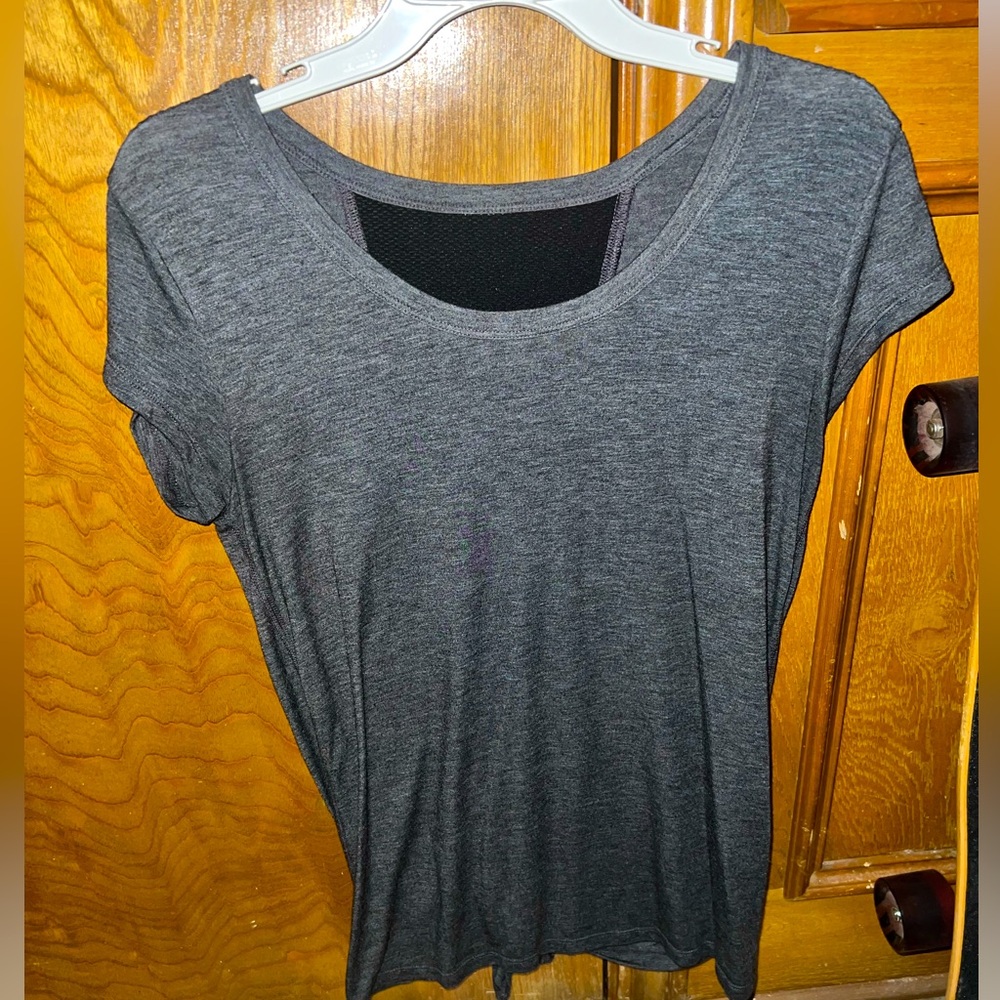 Gray and black short sleeve work out shirt ties in back with opening and mesh